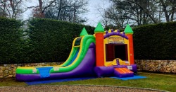 Orange, yellow and purple bounce house with slide Orange, yellow and purple bounce house with slide
